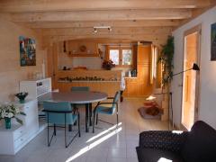 Chalet Les Buissons - (fr)The dining area, with kitchen beyond
